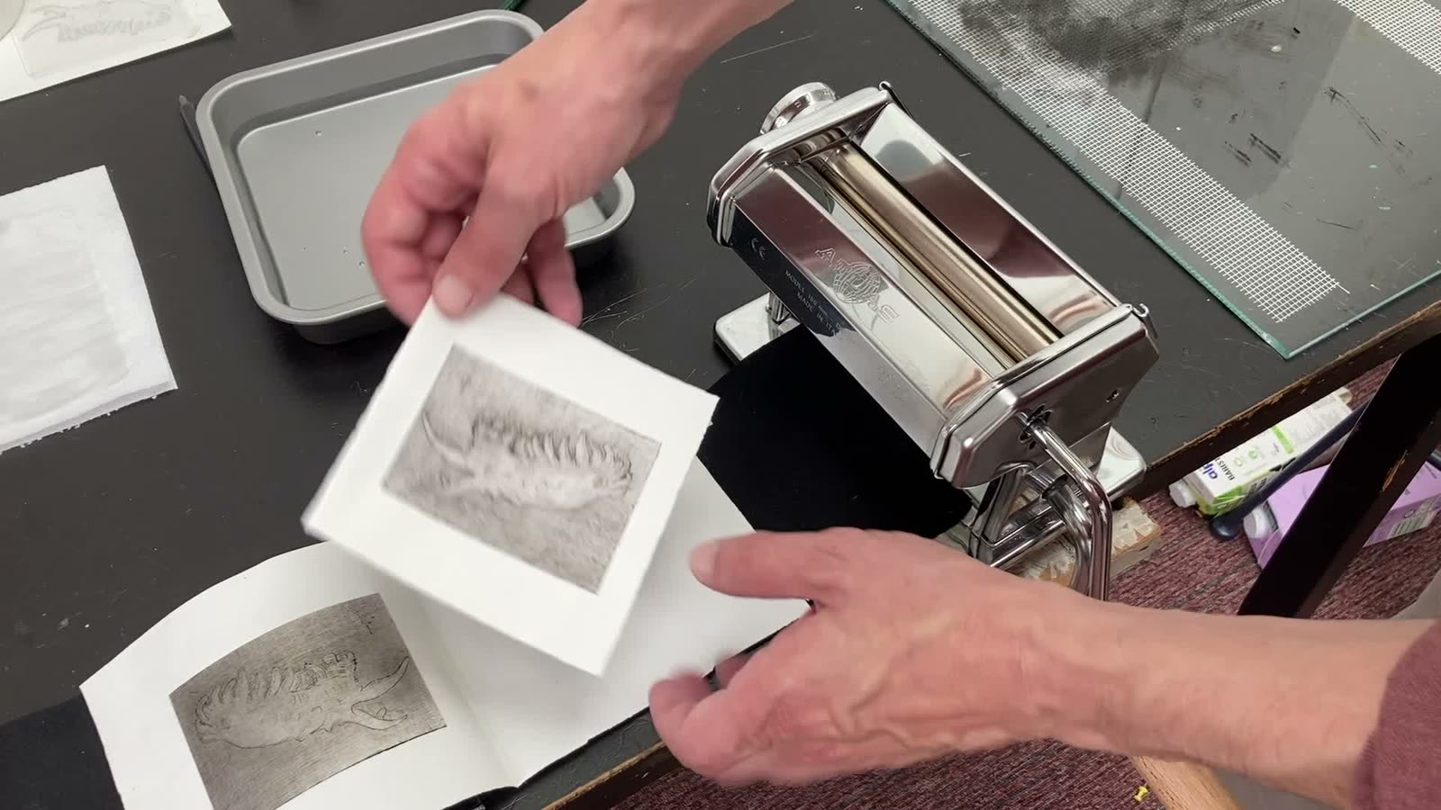 A freshly printed drypoint image made using a pasta machine press
